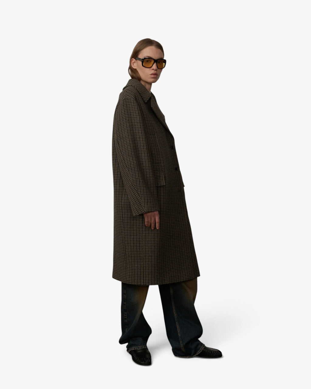 She Stories model wearing a Herskind wool-blend check Cat coat with oversized lapels and dark denim jeans
