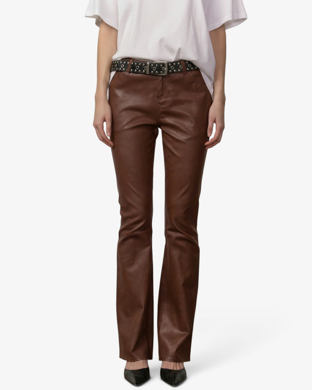 Model wearing She Stories Herskind chestnut brown lamb leather Mathew pants with a white t-shirt and studded belt