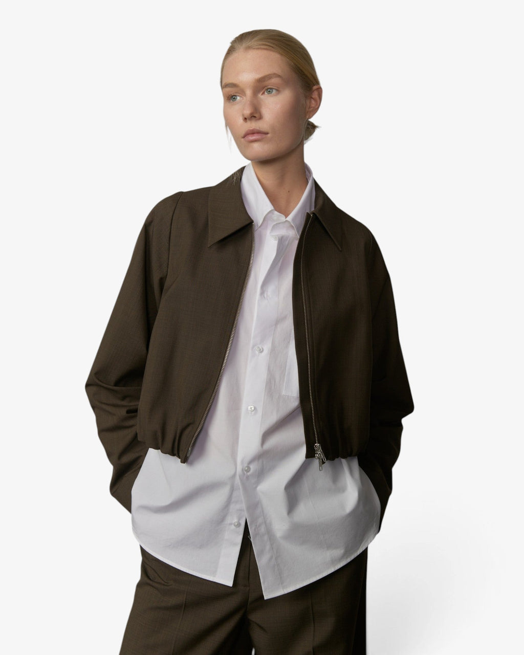 Model wearing a She Stories Herskind Stella khaki cropped jacket with a white shirt and matching trousers
