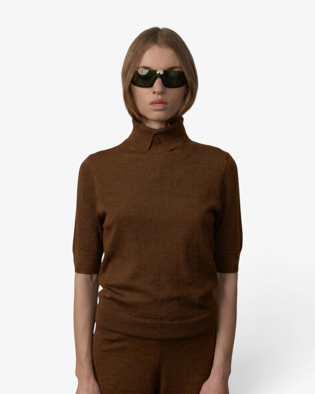 Model wearing a tobacco brown Herskind Perry knit blouse and matching wide-leg trousers in fine Merino wool