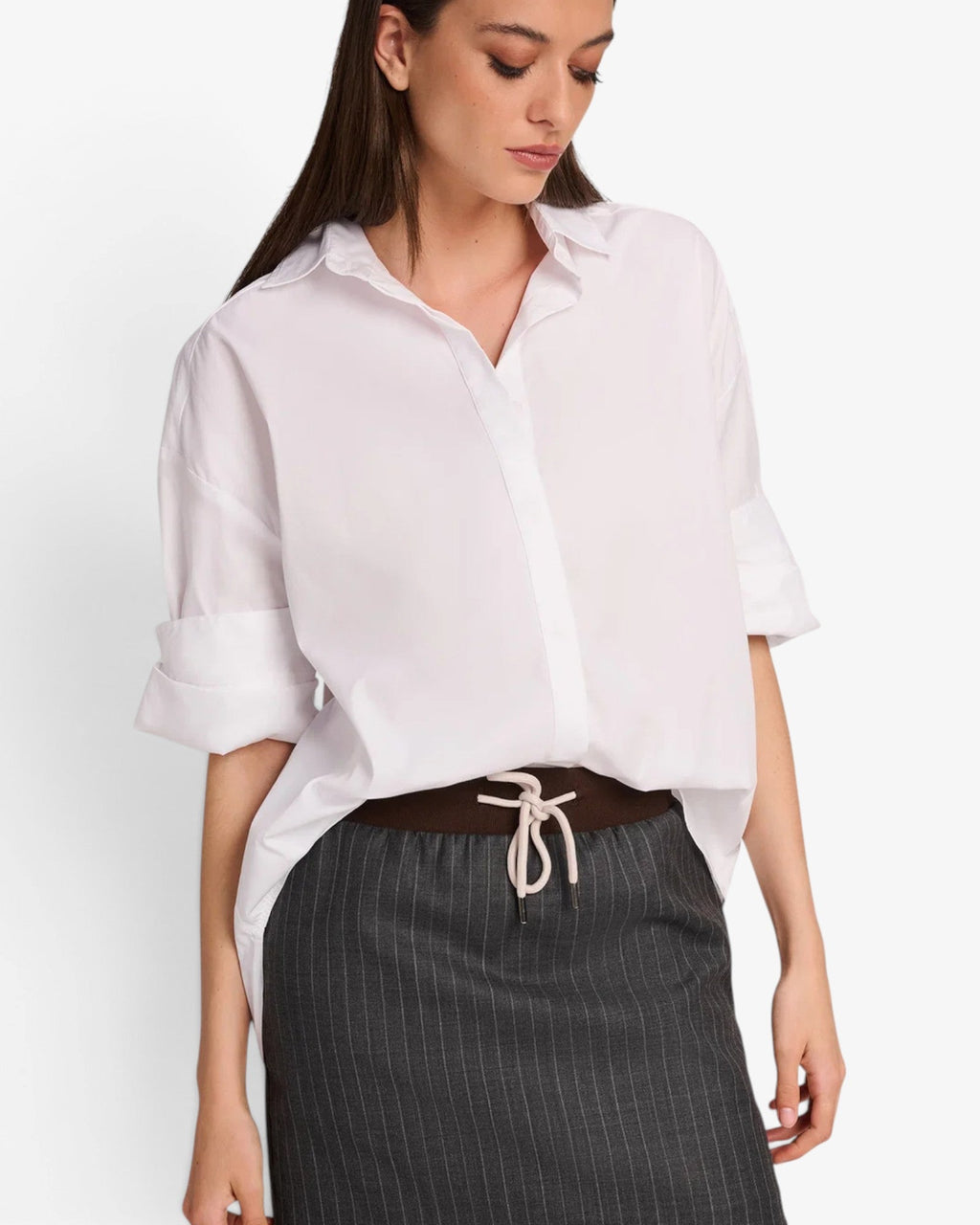 She Stories March23 white poplin blouse with a classic collar and stylish rolled short sleeves